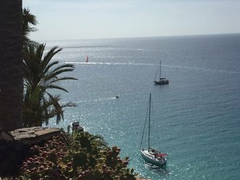 High angle view of sailboats in sea against sky