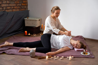 Woman sitting on floor at home