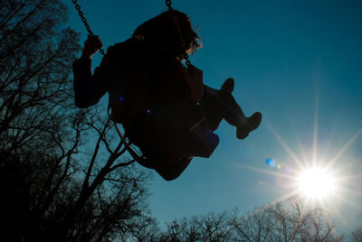 Low angle view of silhouette trees against sky during sunset