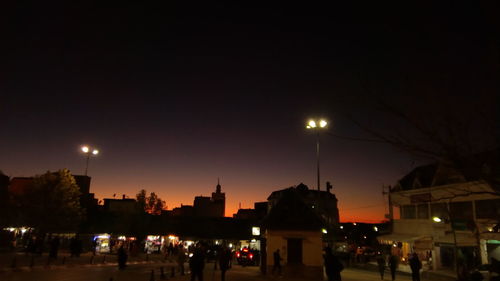 Illuminated city against sky at night