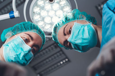 Directly below shot of surgeons at hospital