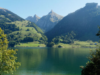 Scenic view of lake and mountains against sky