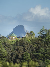 Scenic view of trees and mountains against sky