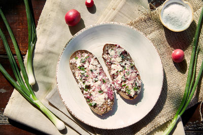 Smearing healthy radish on sourdough bread. radish butter toast. healthy appetizer radish smearing