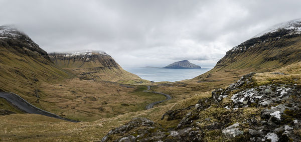 Panoramic view seashore against cloudy sky