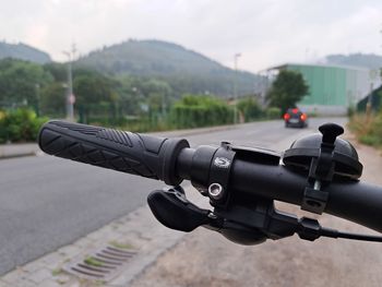 Cropped image of bicycle-handlebar on street 