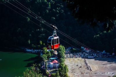 High angle view of overhead cable cars against trees