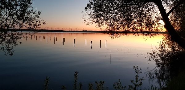 Scenic view of lake against sky during sunset