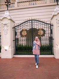 Full length of woman standing against entrance