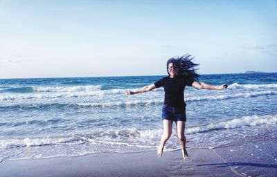 Full length of woman walking on beach