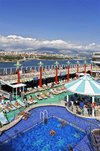 High angle view of swimming pool by sea against blue sky