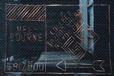 Full frame shot of chainlink fence with building