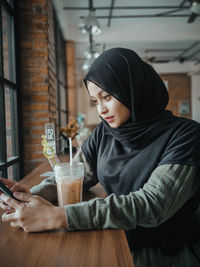 Woman drinking glass on table