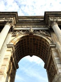 Low angle view of historic building against cloudy sky