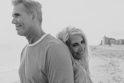 Smiling couple romancing at beach