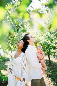 Couple with daughter standing at farm