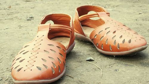 High angle view of shoes on sand at beach