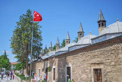 Low angle view of flag on building against sky