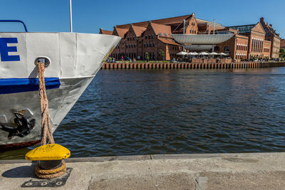 Man by river against building