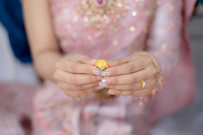 Midsection of woman holding flower