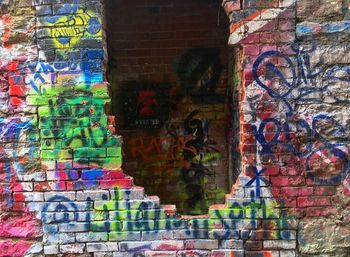 Close-up of graffiti on brick wall