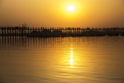 Scenic view of sea against romantic sky at sunset