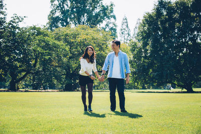 Laughing couple standing at park