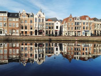 Reflection of buildings in lake against sky