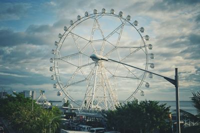 Low angle view of ferris wheel against sky