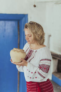 Portrait of smiling young woman holding food