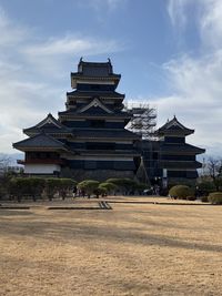 View of matsumoto castle against cloudy sky