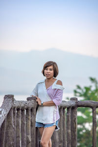 Portrait of woman standing against sky during sunset