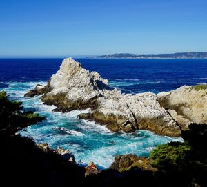 Scenic view of sea against clear blue sky