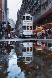 Reflection of buildings in puddle on canal