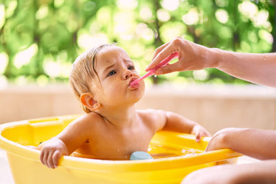 Mother bathing daughter