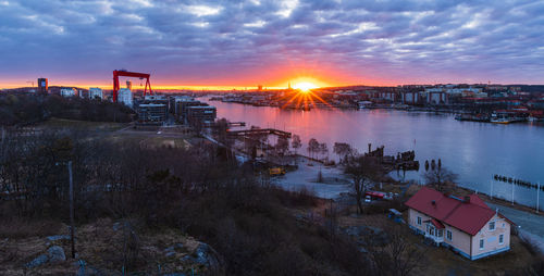 A stunning gothenburg sunrise over the river with cloud-filled skies creating a beautiful cityscape.