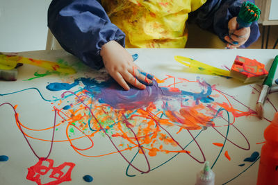 Low angle view of man painting on table