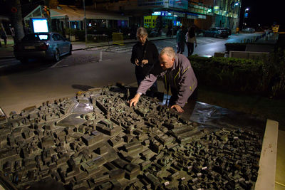 Man and woman looking at cityscape model