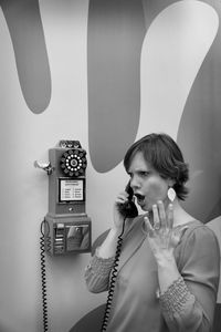 Angry woman using telephone