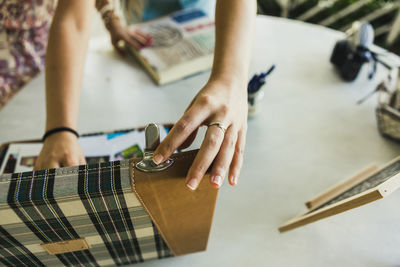 Midsection of woman with box on table