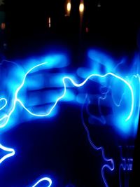 Close-up of illuminated light painting against black background