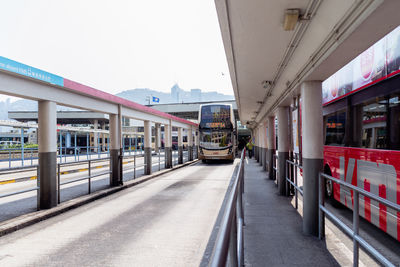 Train on road in city against sky