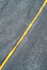 High angle view of yellow road marking on street