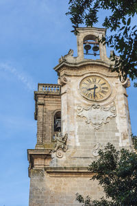 Low angle view of clock tower against sky