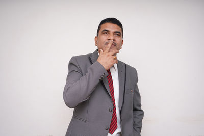 Portrait of a serious young man over white background