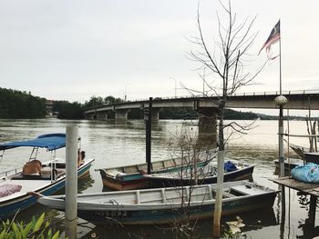 Boats moored at riverbank