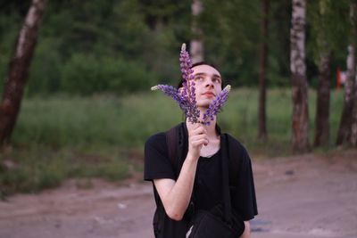 Full length of woman standing against purple tree