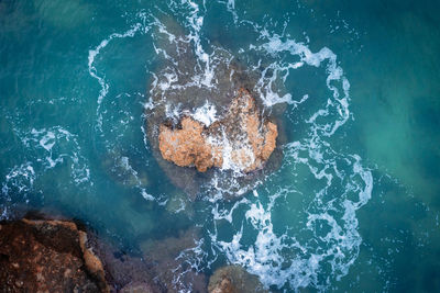 High angle view of rock in sea