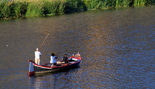 People sitting on boat in lake