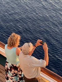 Rear view of people looking at sea